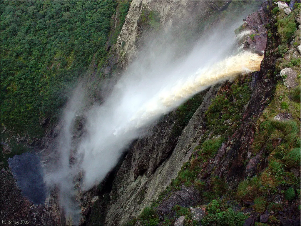 A hiker beside a tall waterfall in the Chapada Diamantina highlands