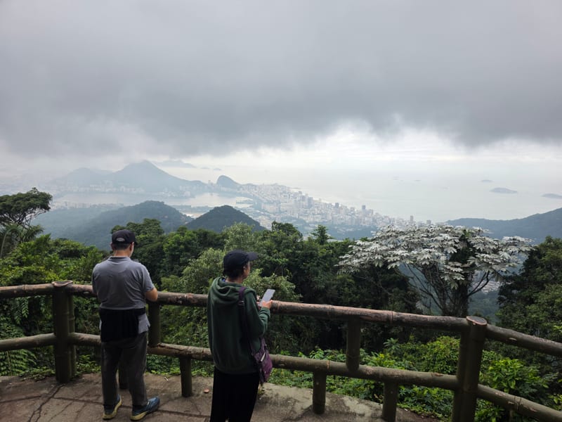 Travellers at a Rio de Janeiro mountain viewpoint