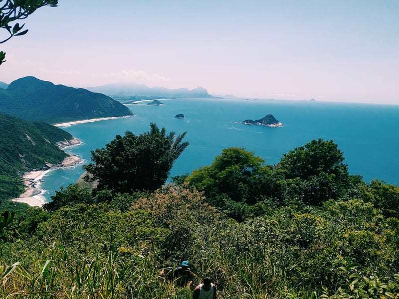 Forested green hills meeting the ocean along the wild coast west of Rio de Janeiro
